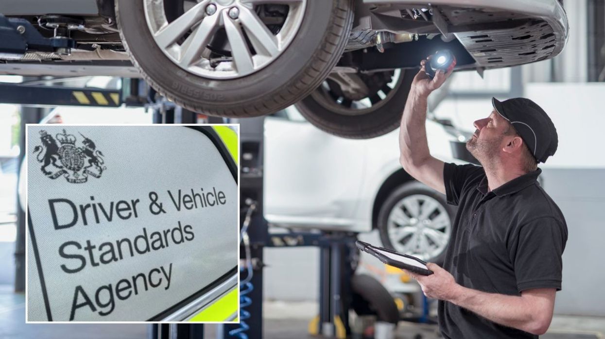A mechanic conducting an MOT test and a DVSA sign
