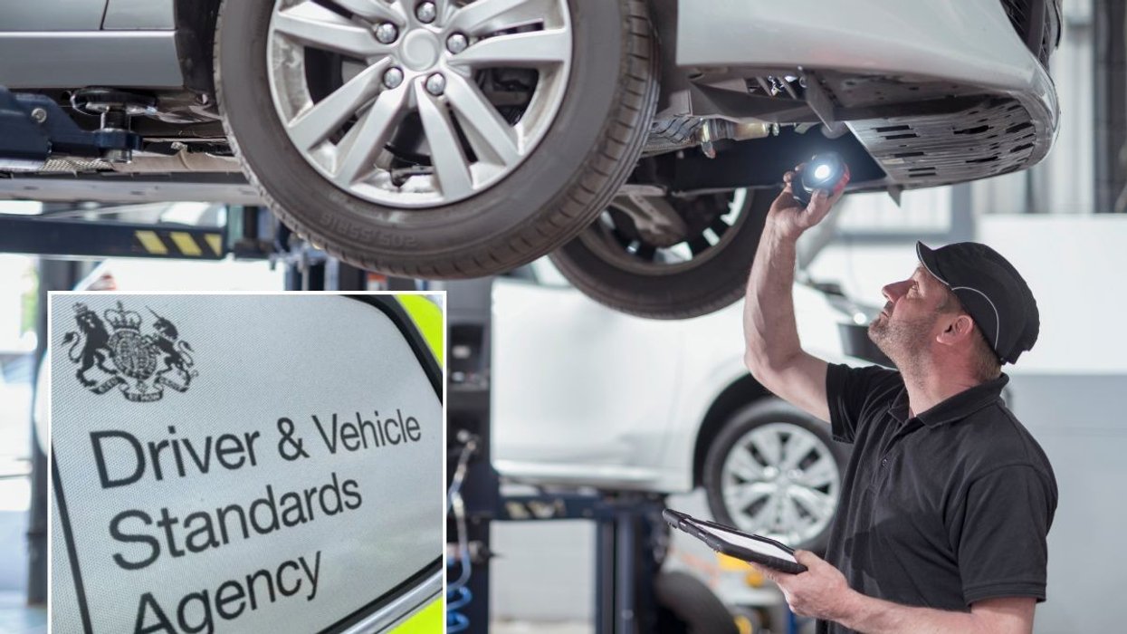 A mechanic conducting an MOT test and a DVSA sign
