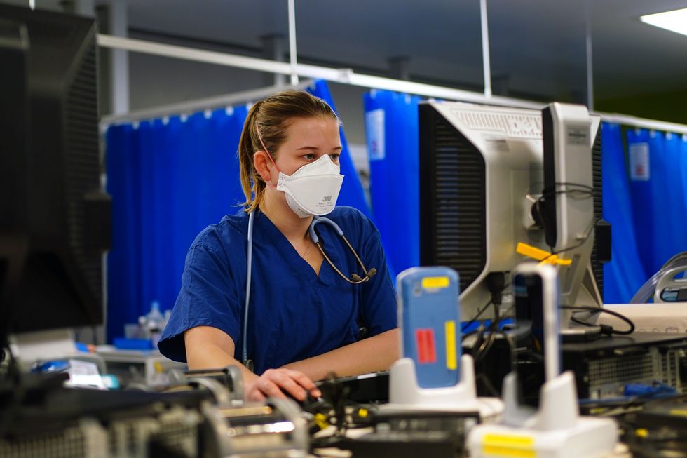A medical staff member wearing an FFP3 face mask in a critical care unit at King's College Hospital, in south east London. Picture date: Tuesday December 21, 2021.