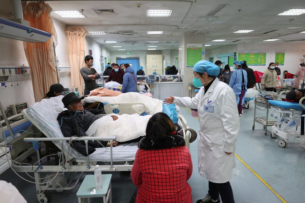 A medical worker attends to a patient at the emergency department of Ganyu District People's Hospital, amid the coronavirus disease (COVID-19) outbreak in Lianyungang, Jiangsu province, China December 28, 2022. China Daily via REUTERS ATTENTION EDITORS - THIS IMAGE WAS PROVIDED BY A THIRD PARTY. CHINA OUT.
