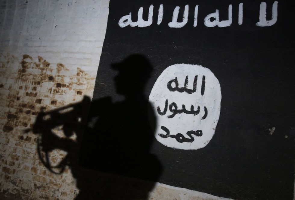 A member of ISIS with an ISIS flag