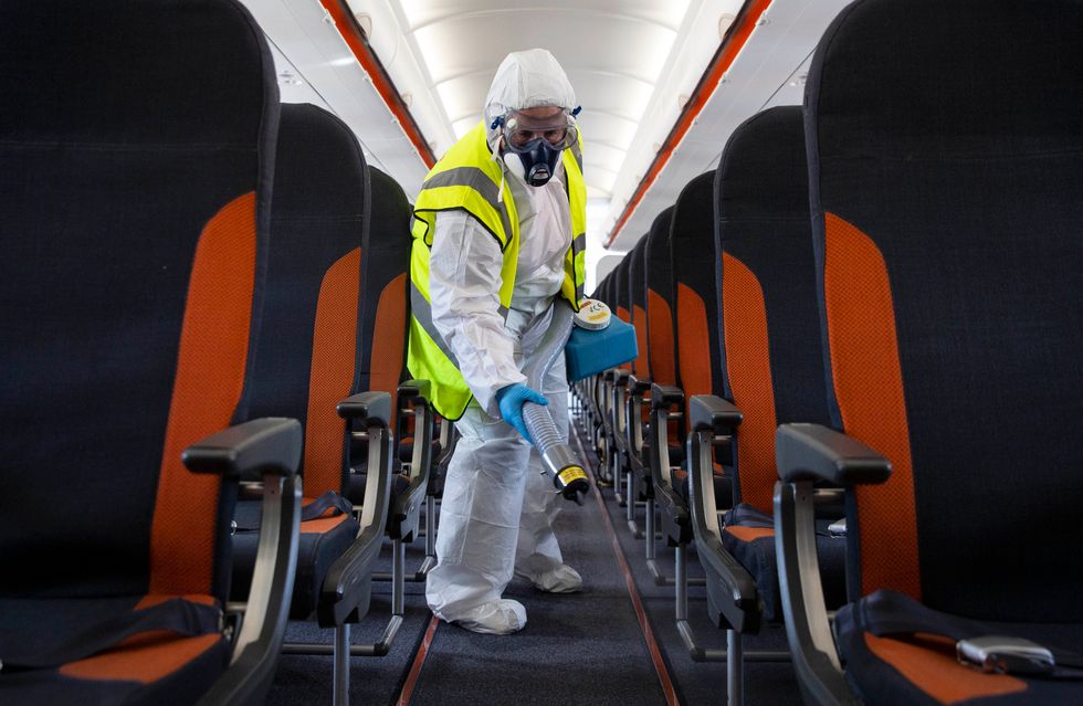 A member of staff taking care of enhanced aircraft cleaning.