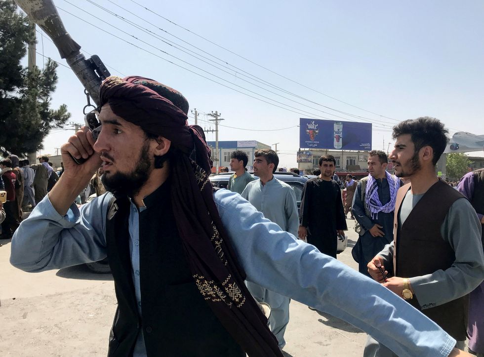 A member of Taliban forces inspects the area outside Hamid Karzai International Airport in Kabul, Afghanistan August 16, 2021.