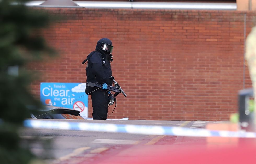 A member of the bomb disposal unit wearing protective equipment at St James's Hospital, Leeds, where patients and staff were evacuated from some parts of the building following the discovery of a suspicious package outside the Gledhow Wing, which houses the majority of its maternity services including the delivery suite. A 27-year-old man from Leeds has been arrested in connection with the matter. Picture date: Friday January 20, 2023.