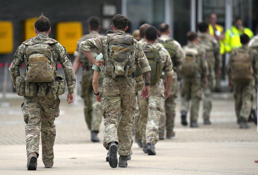 A member of the British armed forces 16 Air Assault Brigade walk to the air terminal after disembarking a RAF Voyager aircraft at RAF Brize Norton, Oxfordshire, following their return from helping in operations to evacuate people from Kabul airport in Afghanistan.