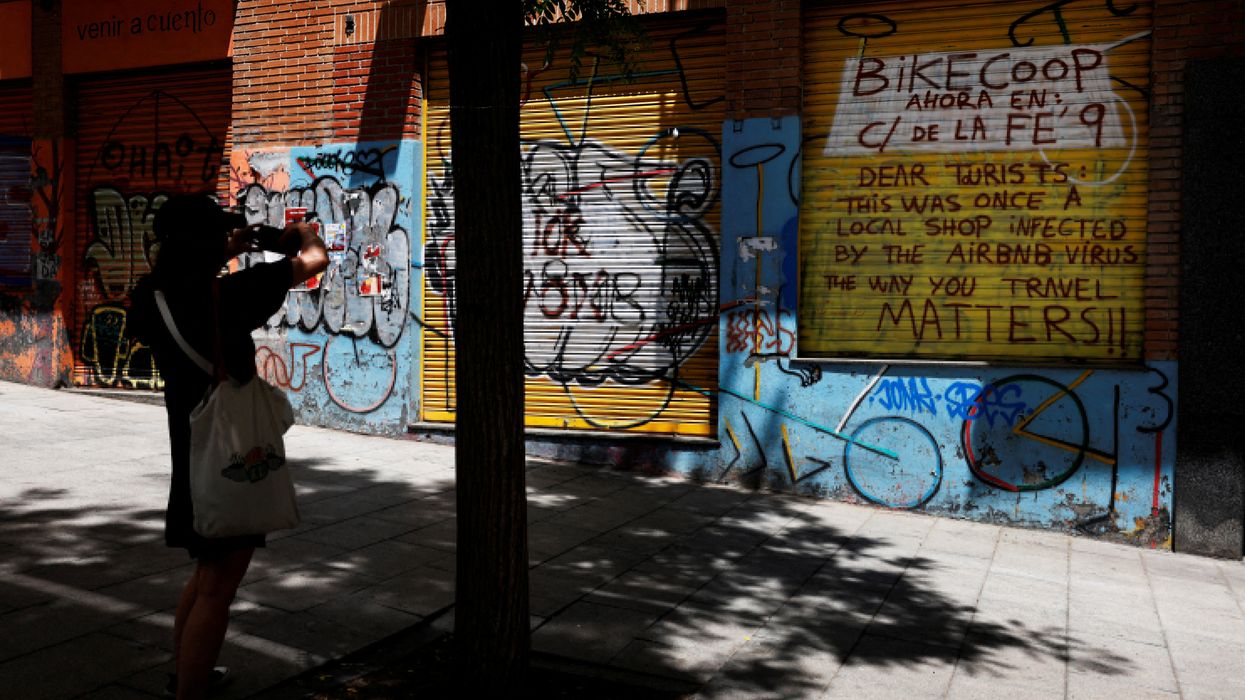 A message for tourists against Airbnb’s vacation rentals on the outside of a former local store in Madrid,
