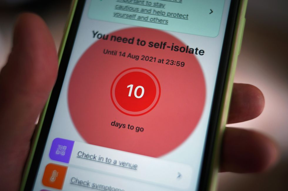 A message to self-isolate, with ten days of required self-isolation remaining, is displayed on the NHS coronavirus contact tracing app on a mobile phone.