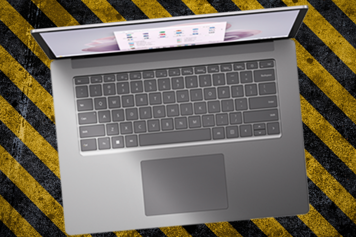 a microsoft surface laptop is pictured on a biohazard warning pattern 
