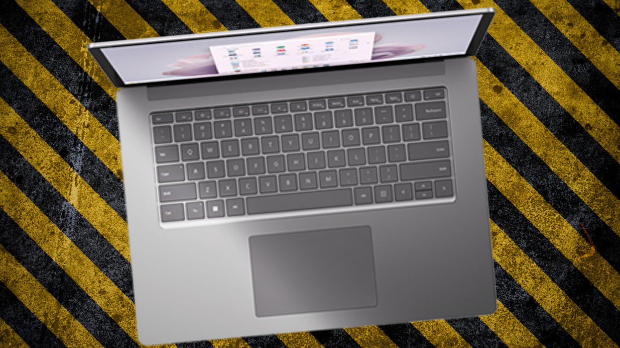 a microsoft surface laptop is pictured on a biohazard warning pattern
