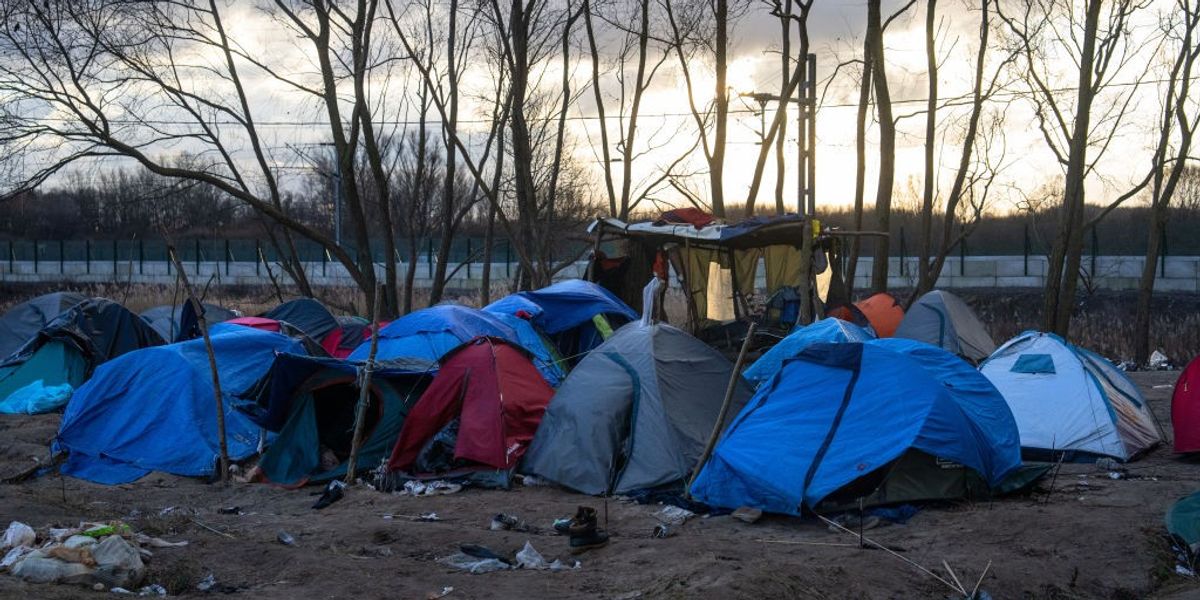 NextImg:Migrant shot dead at French refugee camp as two-year-old child and five others left injured as violence breaks out