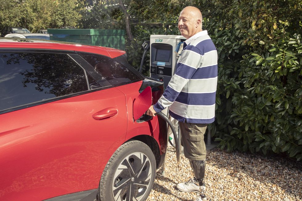 A Motability recipient charging his electric vehicle