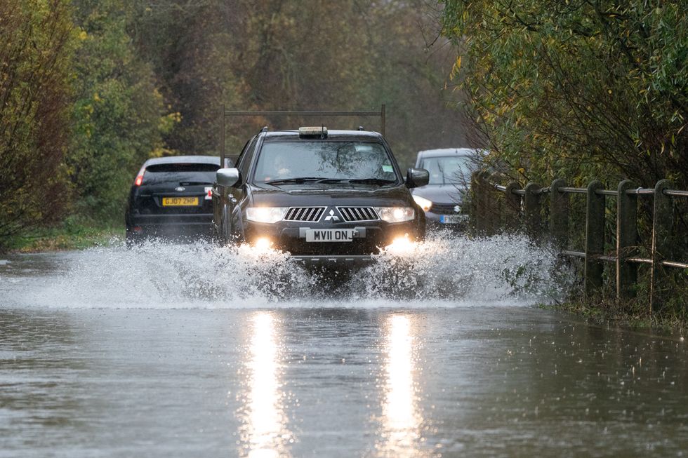 A motorist drives along a flooded road in Mountsorrel, Leicestershire. Motorists are being warned to stay off the roads as cars have become stuck in flood water caused by downpours and the UK prepares to suffer %22miserable conditions%22 over the next two days. Picture date: Thursday November 17, 2022.