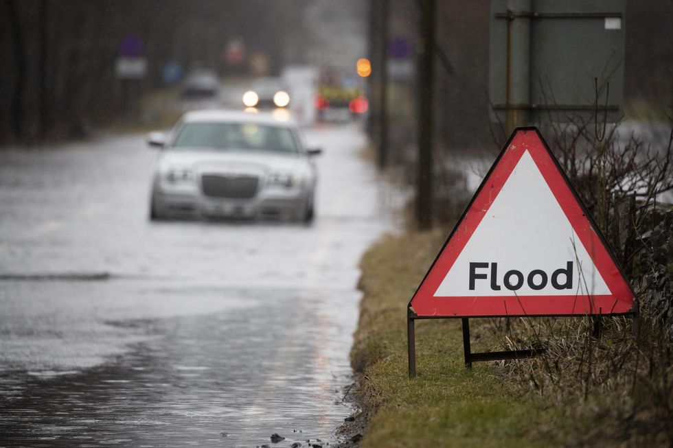 A motorist gets stuck in flood water along the A84 near Callander, Stirlingshire. Picture date: Saturday February 20, 2021.