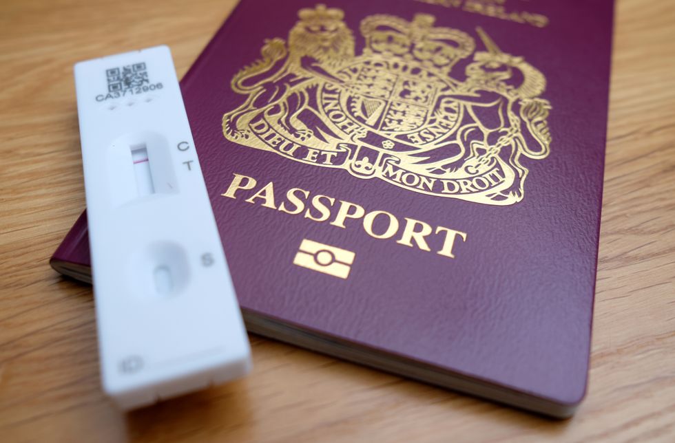 A negative Covid-19 test sits on top of a Passport for the United Kingdom of Great Britain and Northern Ireland. Holidaymakers will finally discover which destinations they can visit this summer without quarantining, with Portugal, Iceland and Malta among those expected to be on the travel green list. Picture date: Friday May 7, 2021.