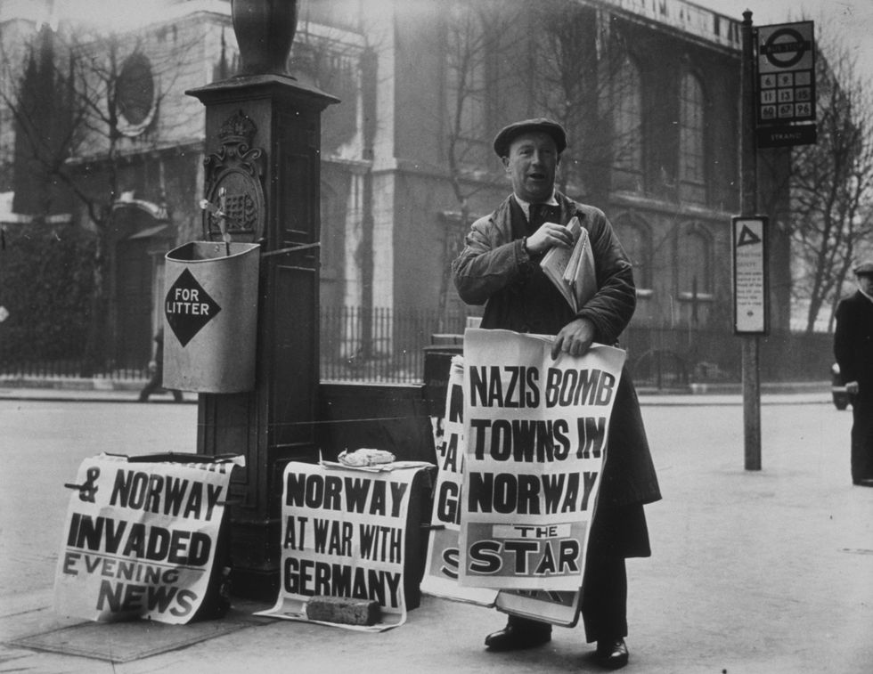 A newspaper seller in London, carrying the news that the Nazis had invaded Norway
