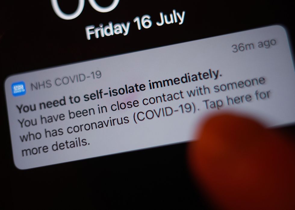 A notification issued by the NHS coronavirus contact tracing app - informing a person of the need to self-isolate immediately, due to having been in close contact with someone who has coronavirus - is displayed on a mobile phone in London, during the easing of lockdown restrictions in England. Picture date: Friday July 16, 2021.