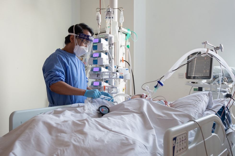 A nurse checks on a patient suffering with Covid-19.
