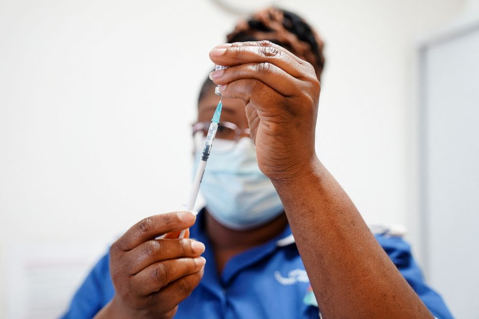 A nurse prepares a dose of a coronavirus disease (COVID-19) vaccine for Margaret Keenan, 91, before receiving her spring COVID-19 booster shot at the University Hospital Coventry, in Coventry, Britain April 22, 2022. Jacob King/Pool via REUTERS