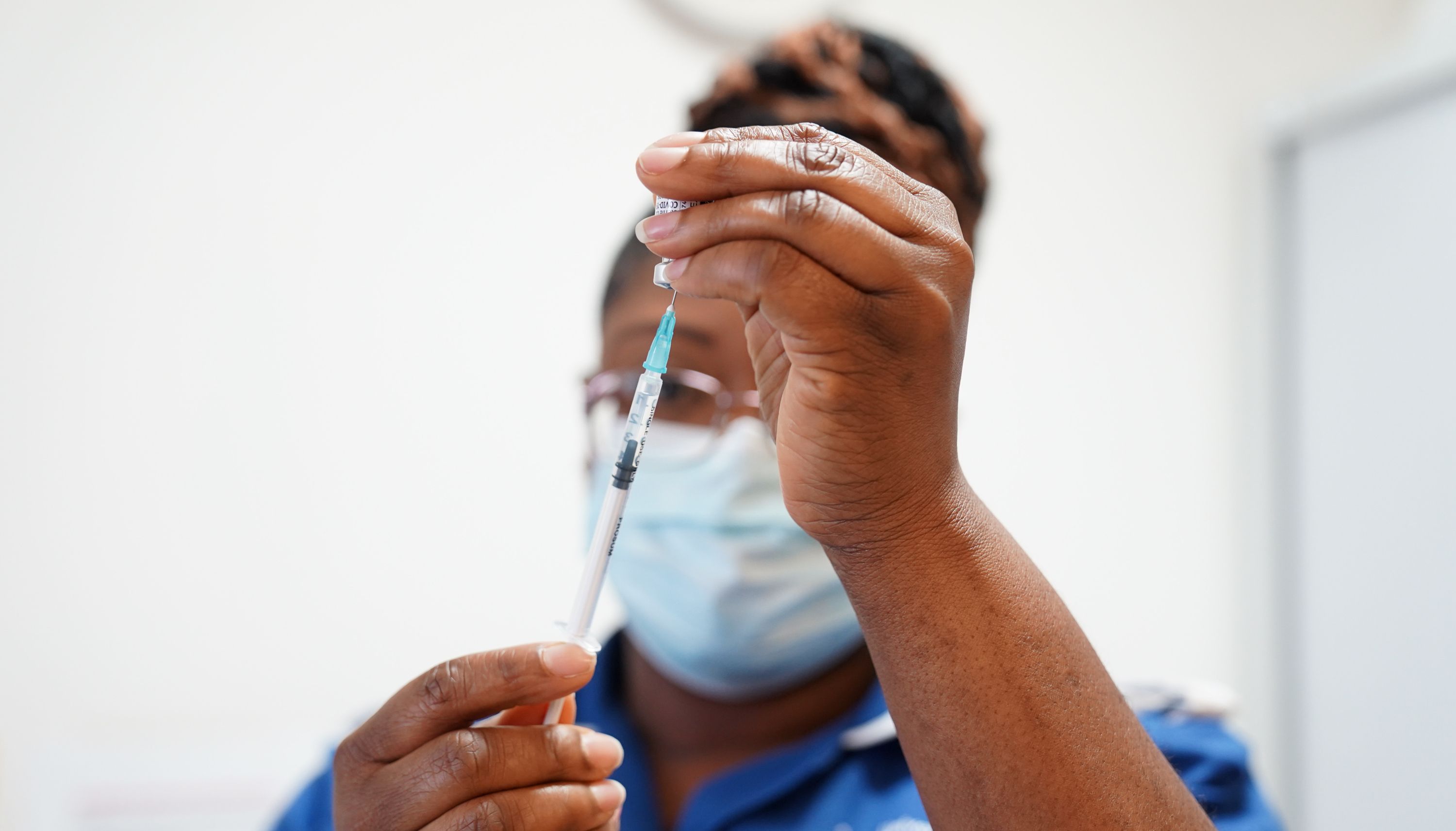 A nurse prepares a dose of a Covid-19 vaccine