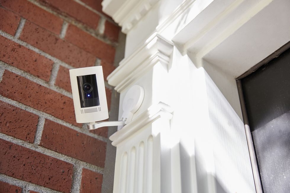 A outdoor home security smart home technology camera looking directly into camera with recording light on