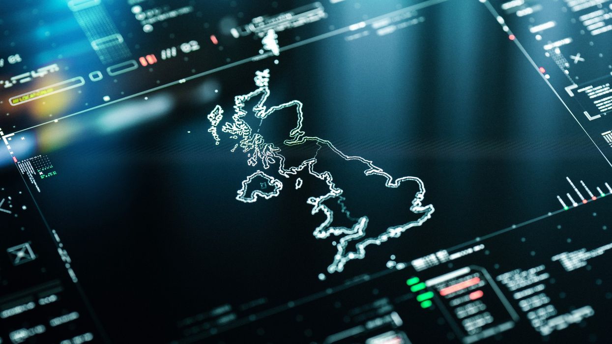 a outline map of the UK is shown on a computer screen with graphs and charts