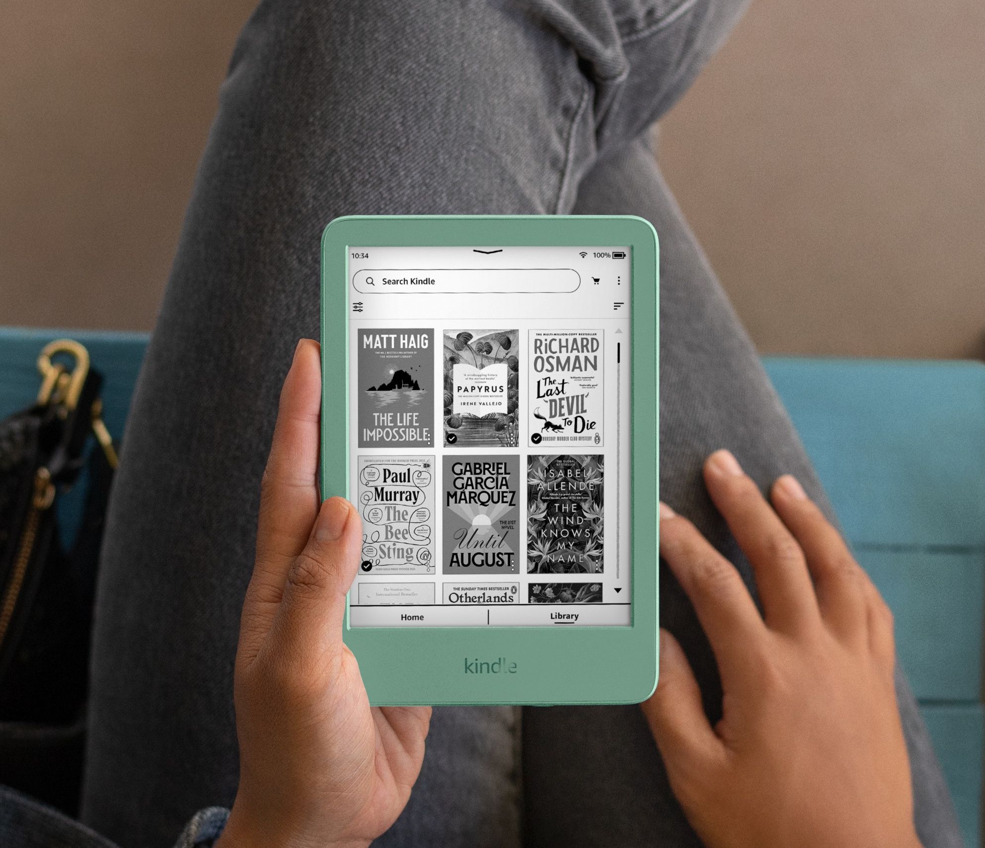 a pair of hands hold the 12th generation kindle in matcha