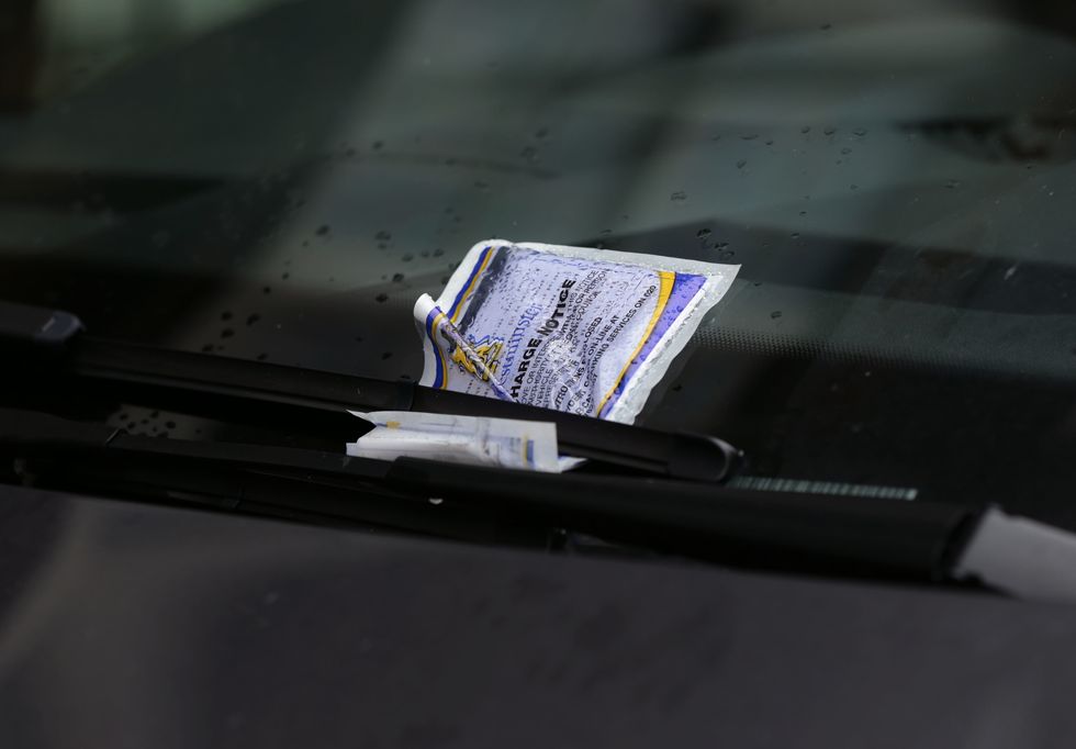 A parking ticket placed on the windscreen of a car in Westminster, London.