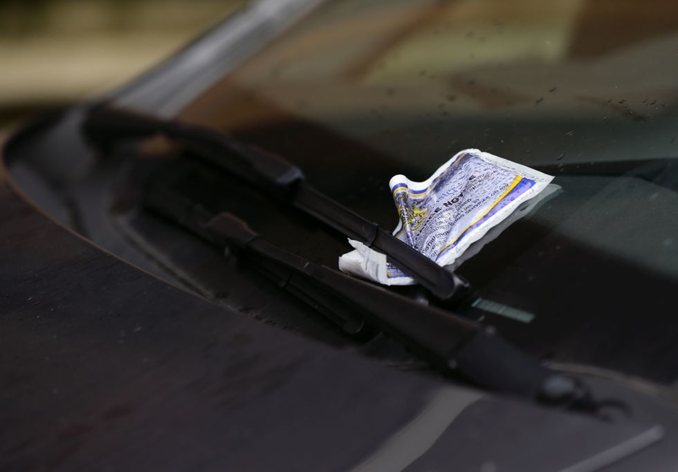 A parking ticket placed on the windscreen of a car in Westminster, London.
