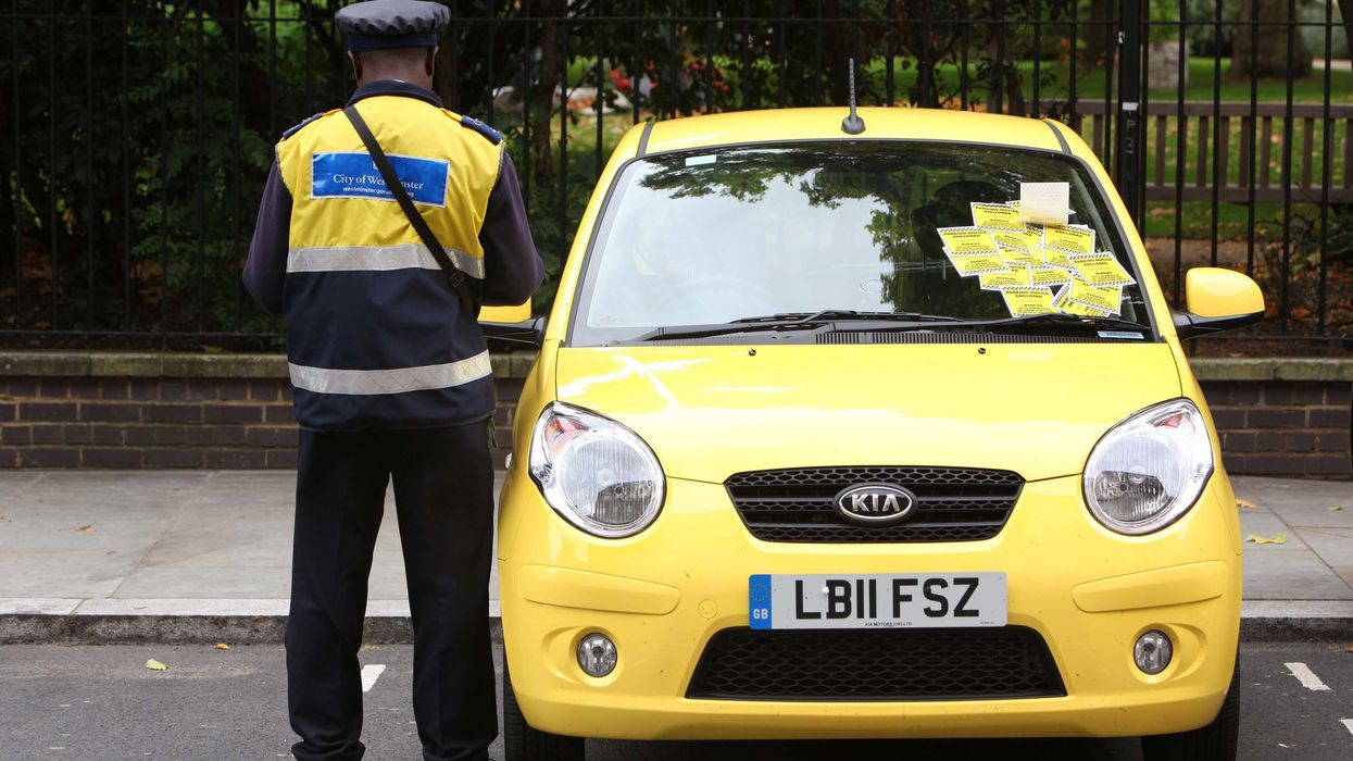 A parking warden issuing fines