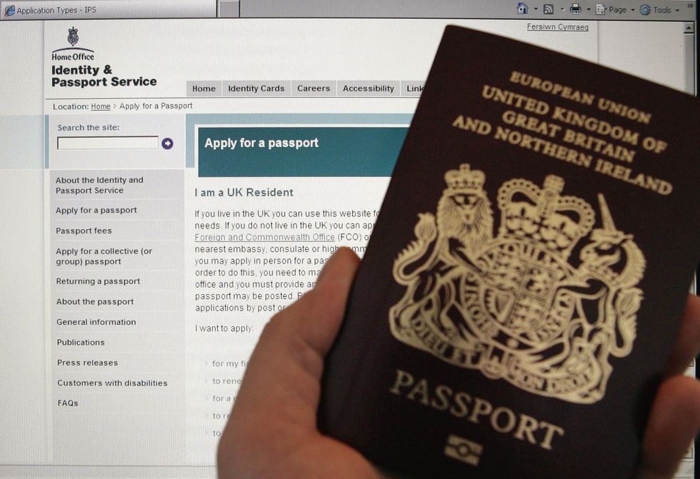 A passport is held up in front of a screen