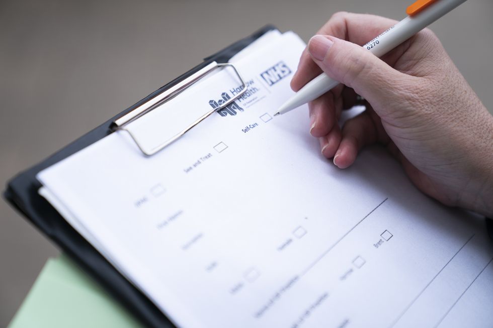 A patient form to be filled in on arrival, advising if they should self-care or be admitted, outside the Accident and Emergency department at Northwick Park Hospital in Harrow, north London. The hospital is trialing a new scheme which places a GP and nurse outside A and E departments to redirect non-urgent cases, which is hoped will save the NHS millions. Picture date: Tuesday February 8, 2022.