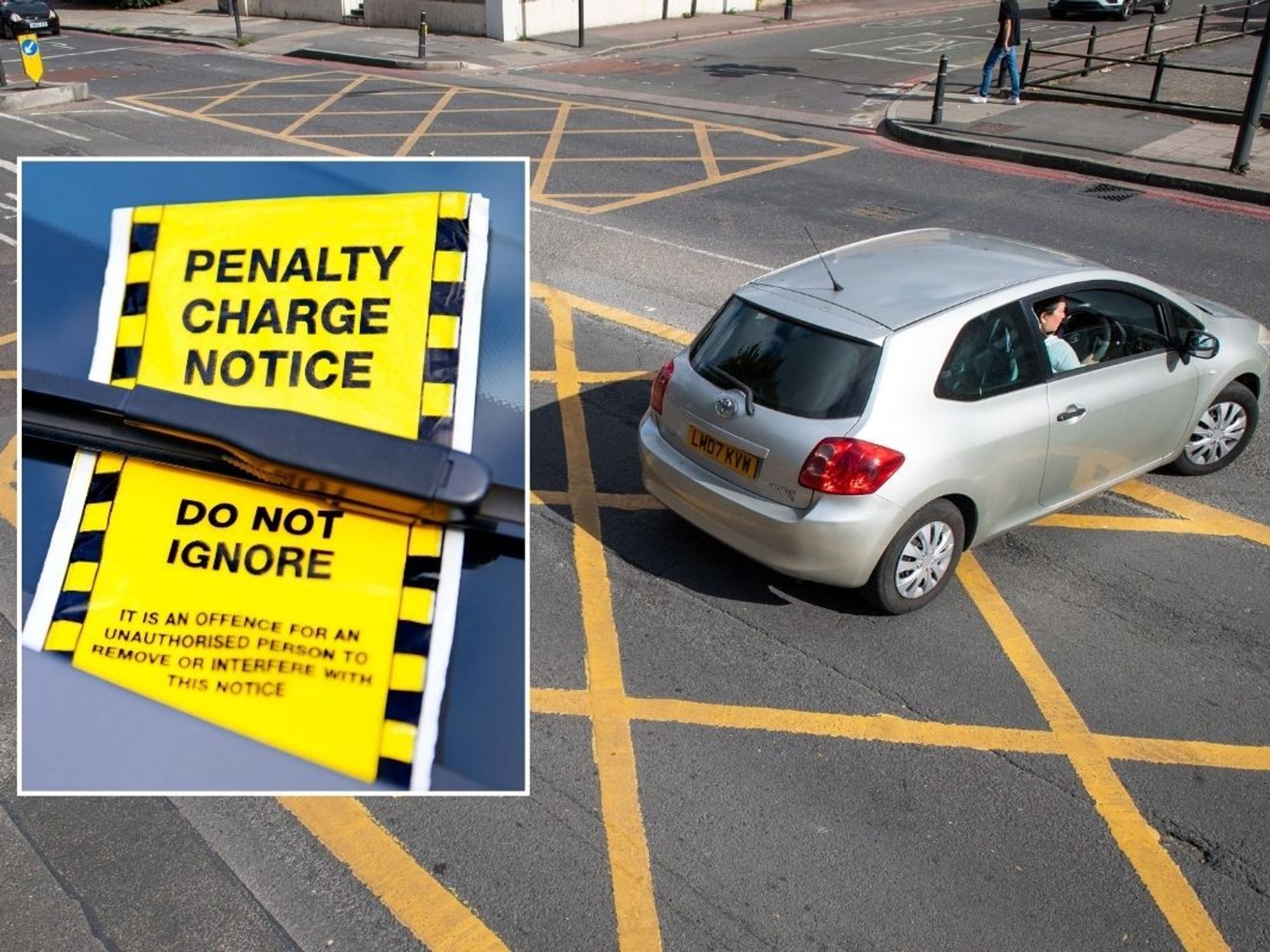 A penalty charge notice and a car driving inside a yellow box junction