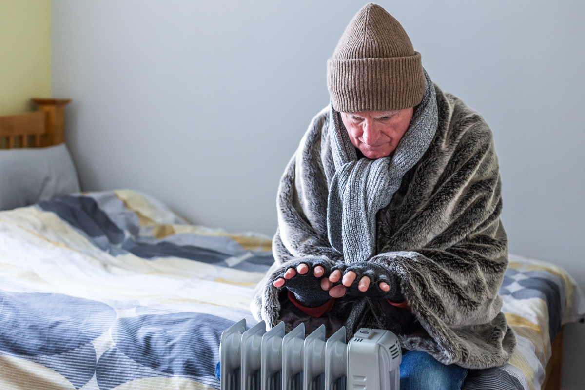 A pensioner warming themselves