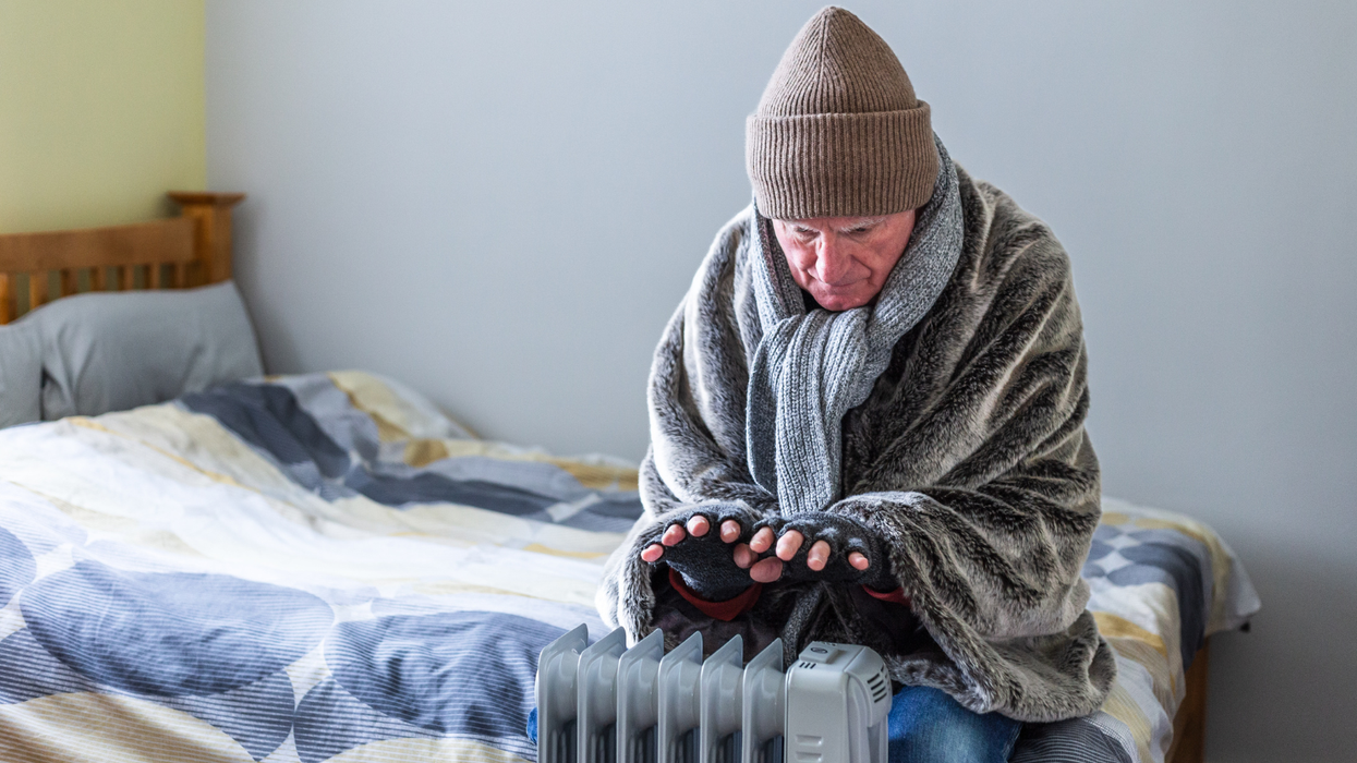 A pensioner warming themselves