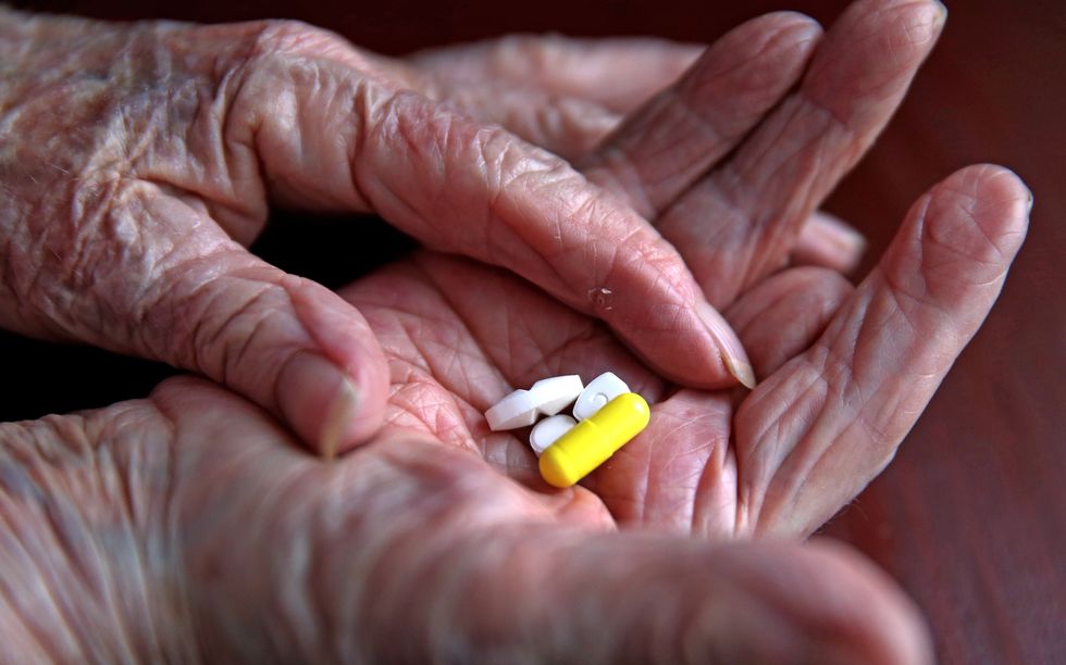 A pensioner with her daily prescription drugs.