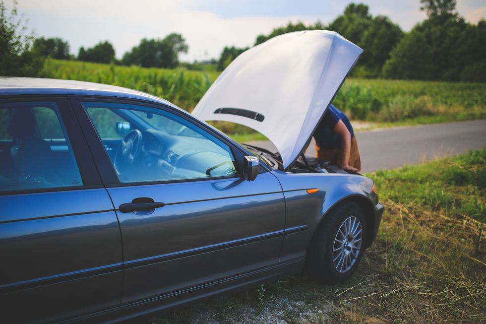 A person checking his car engine