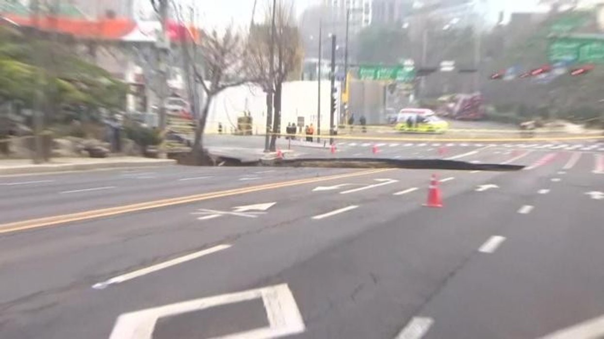 One person dead after giant 65ft sinkhole opens up and swallows motorbike