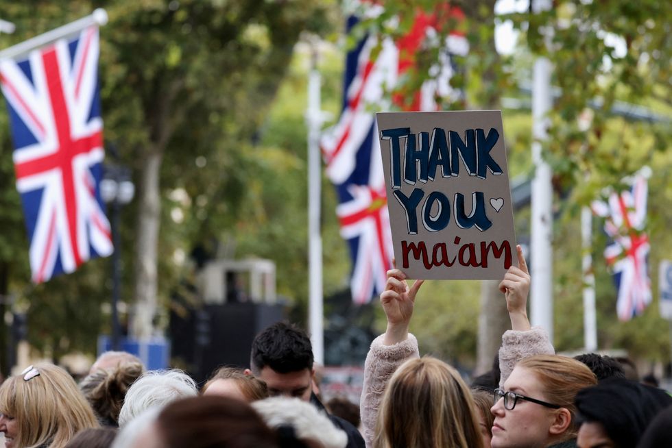 A person holds a sign near The Mall on the day of the state funeral and burial of Britain\u2019s Queen Elizabeth in London, Britain September 19, 2022. REUTERS/Kevin Coombs