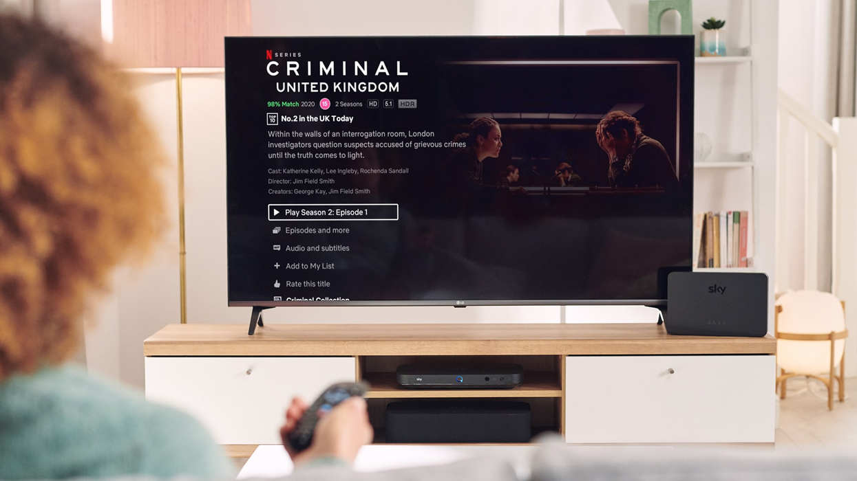 a person holds out their sky tv remote to select an episode of a netflix show on sky tv