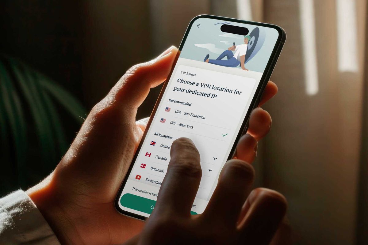 a person holds the expressvpn app on iPhone