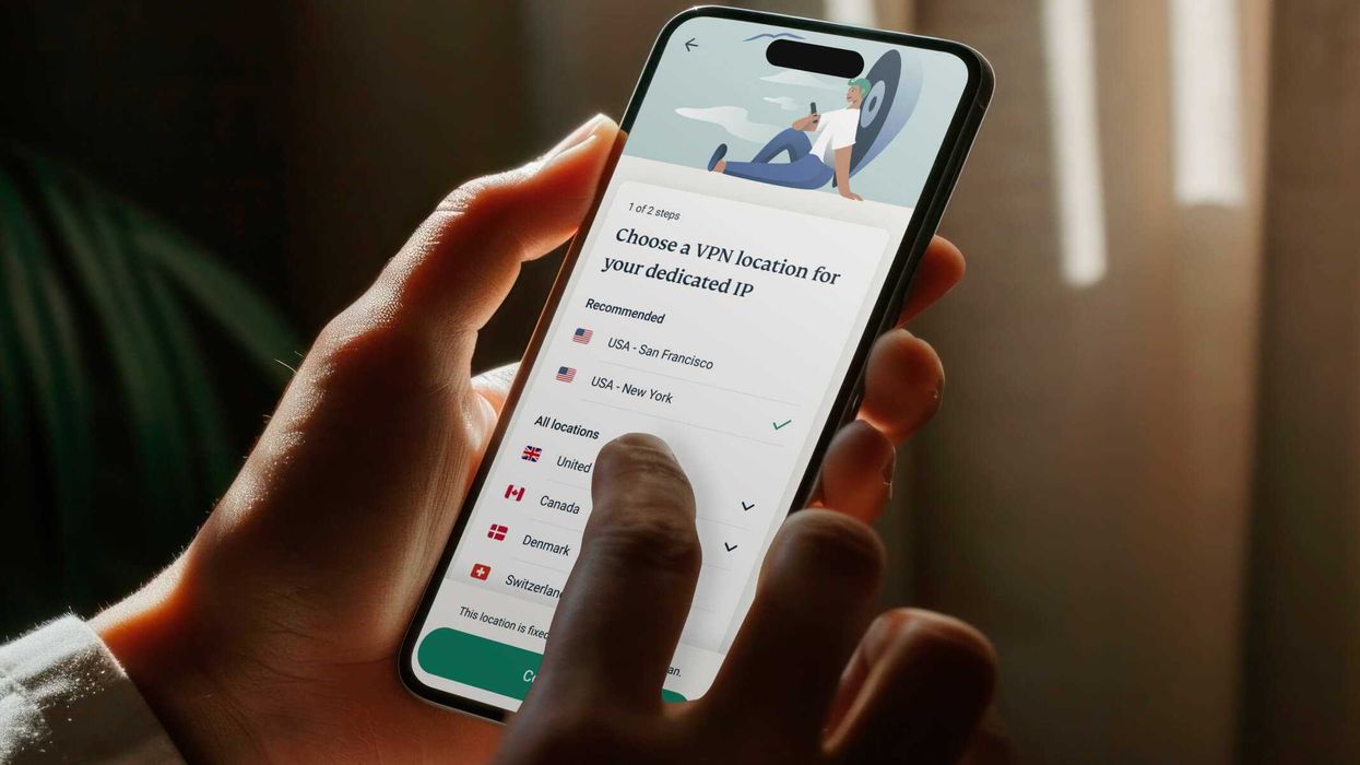 a person holds the expressvpn app on iPhone