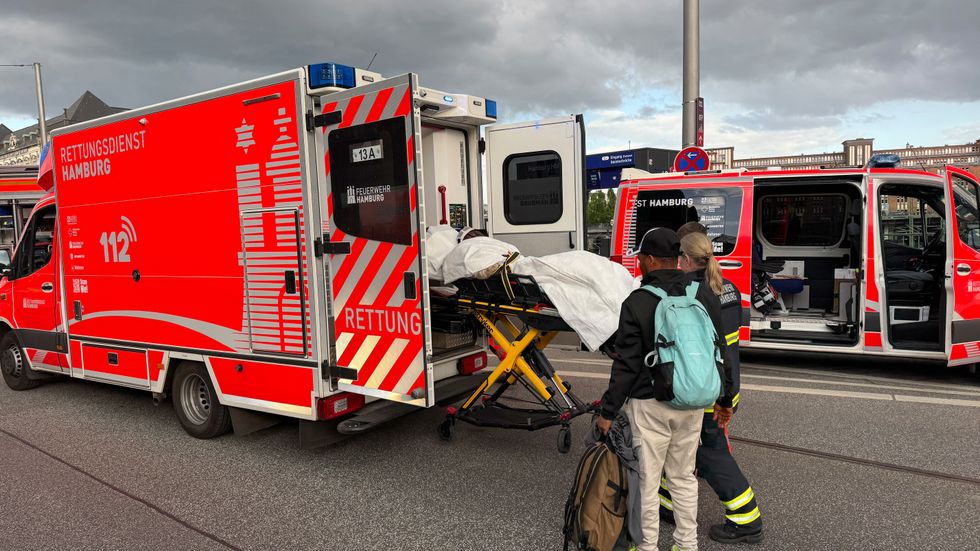 A person is loaded into an ambulance following the attack at Hamburg station