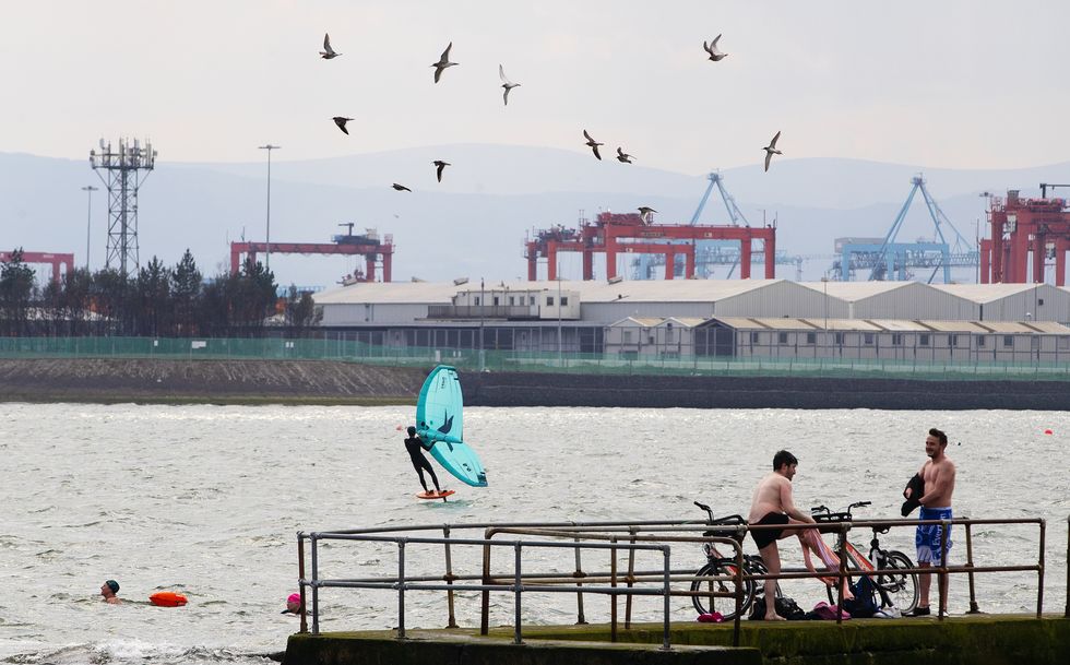 A person on a hydrofoil kiteboard in Dublin Bay on a sunny spring day in Dublin. Picture date: Thursday April 15, 2021.