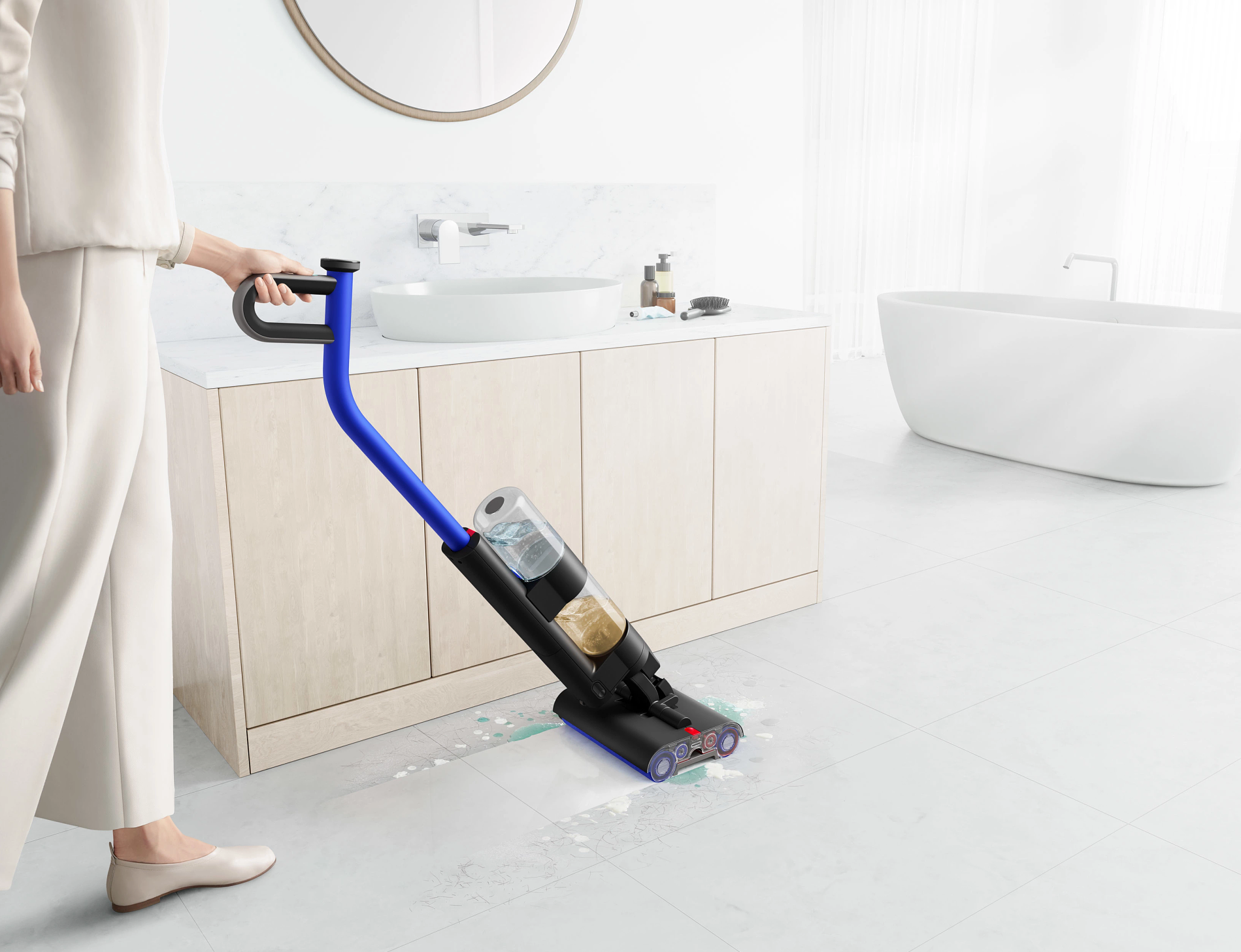 a person pictured pushing the dyson wash g1 around a bathroom