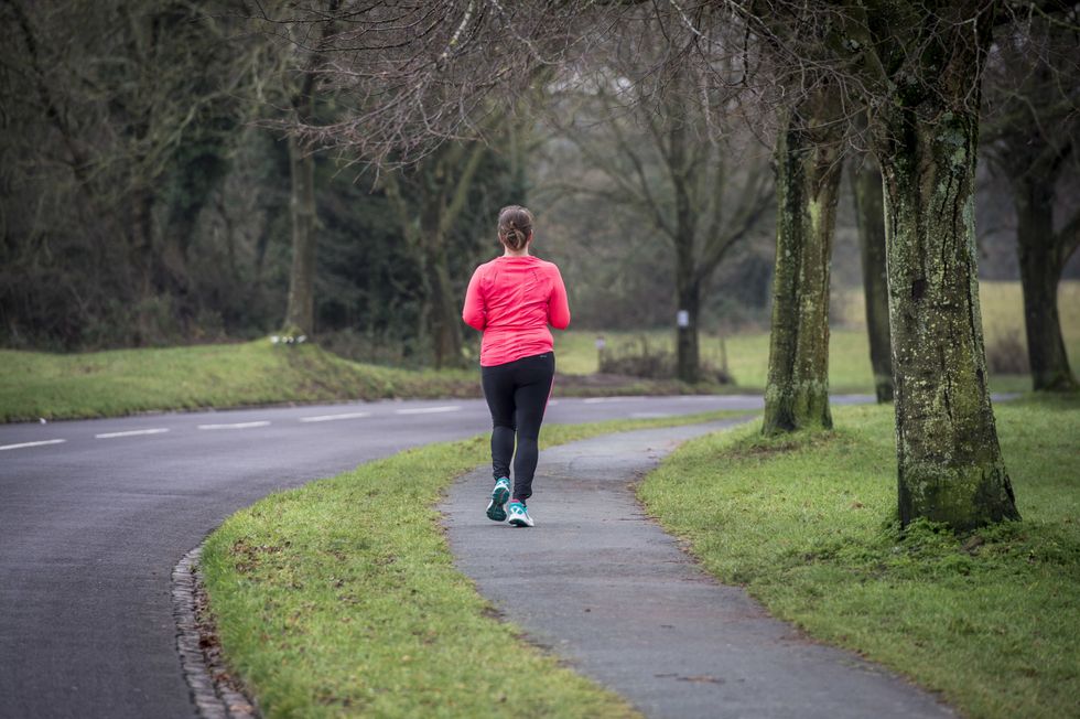 A person running along a road