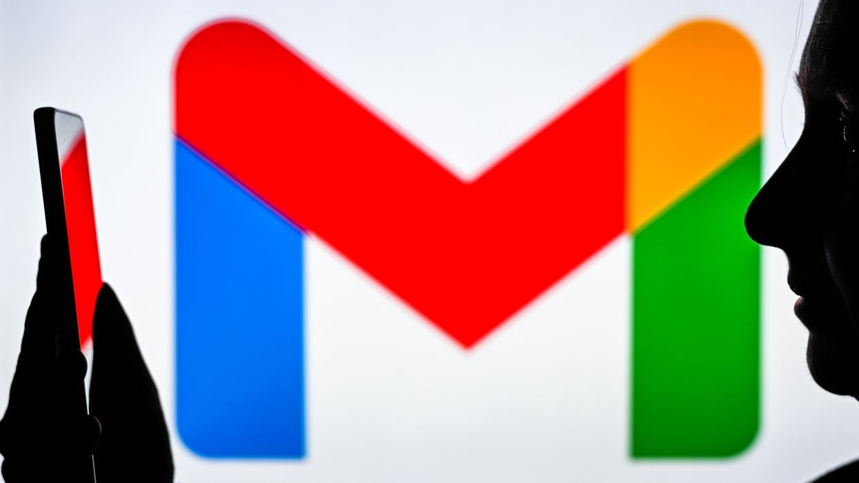a person staring at their phone with the gmail logo pictured in the background
