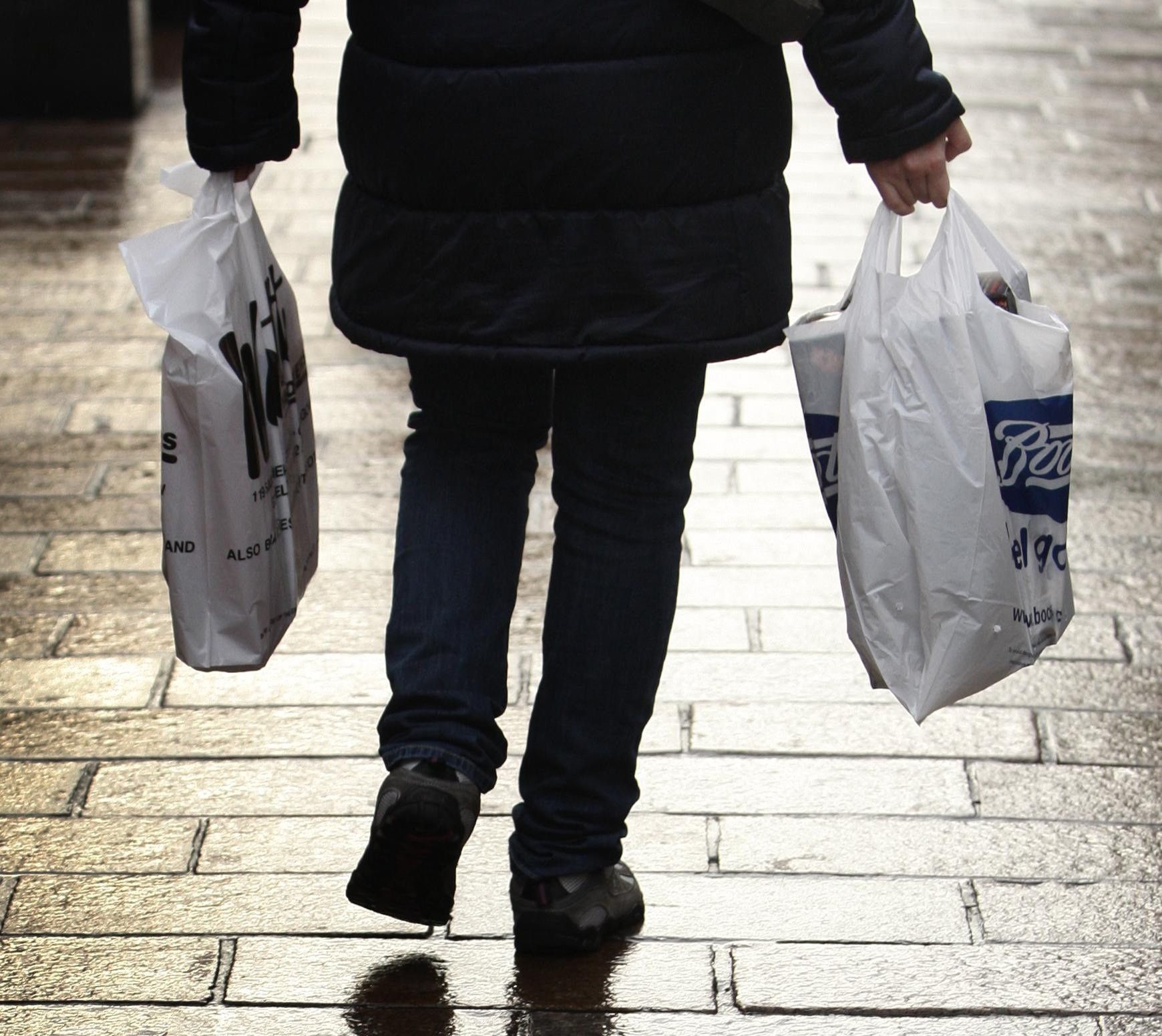 A person walking down a street with bags
