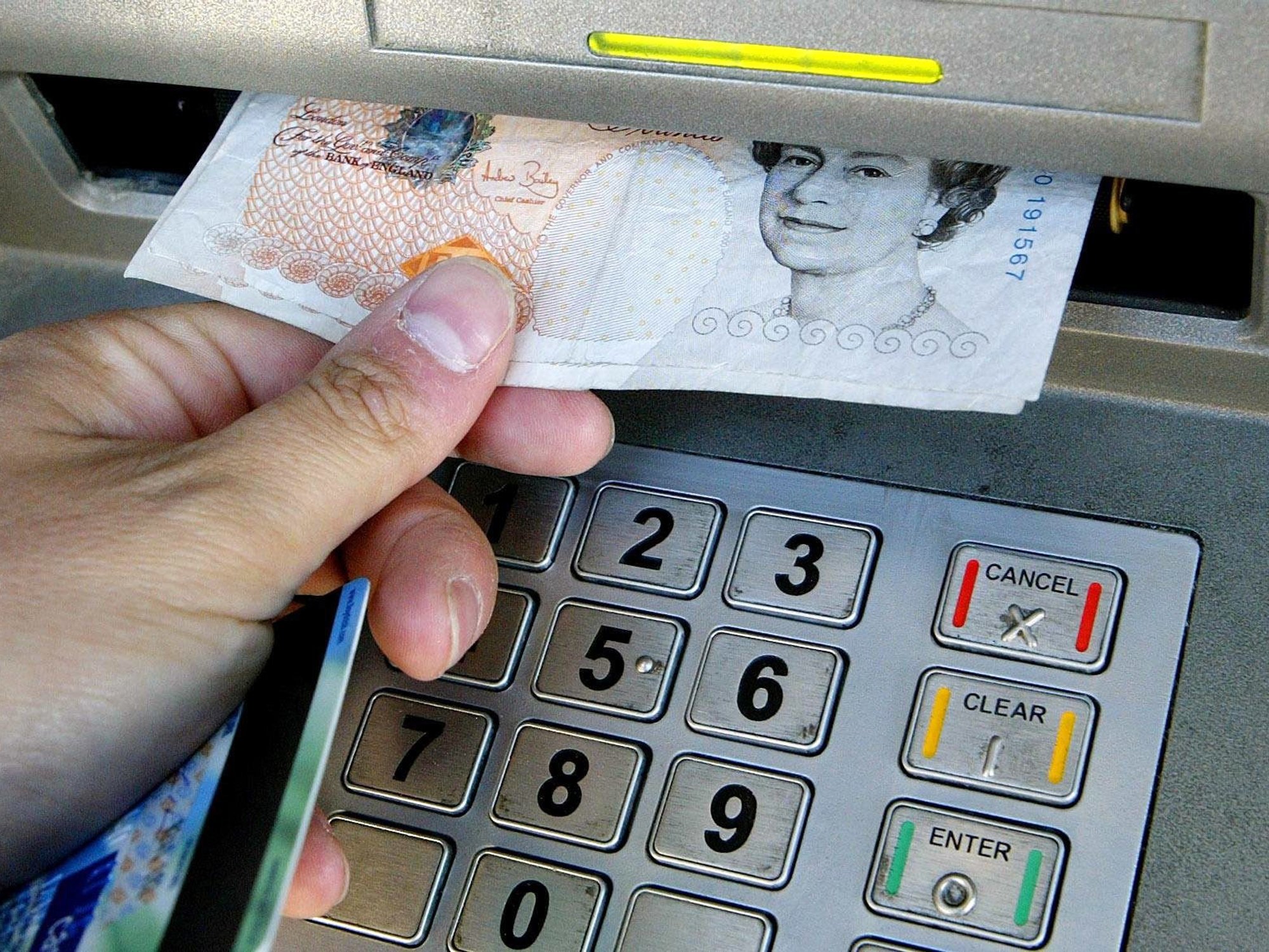 A person withdraws money from a cash machine