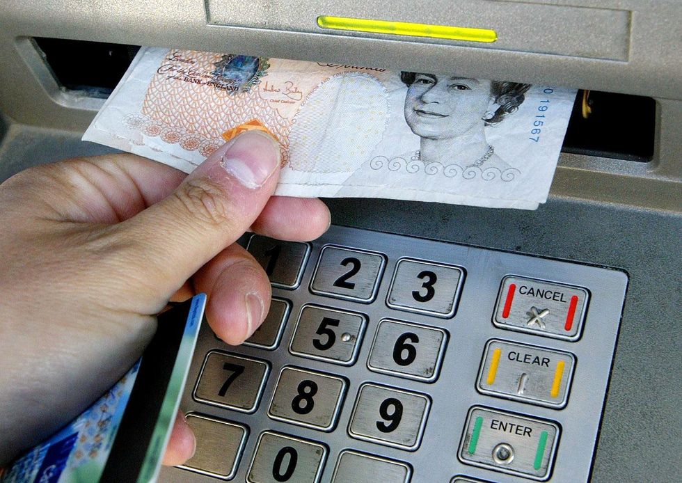 A person withdraws money from a cash machine