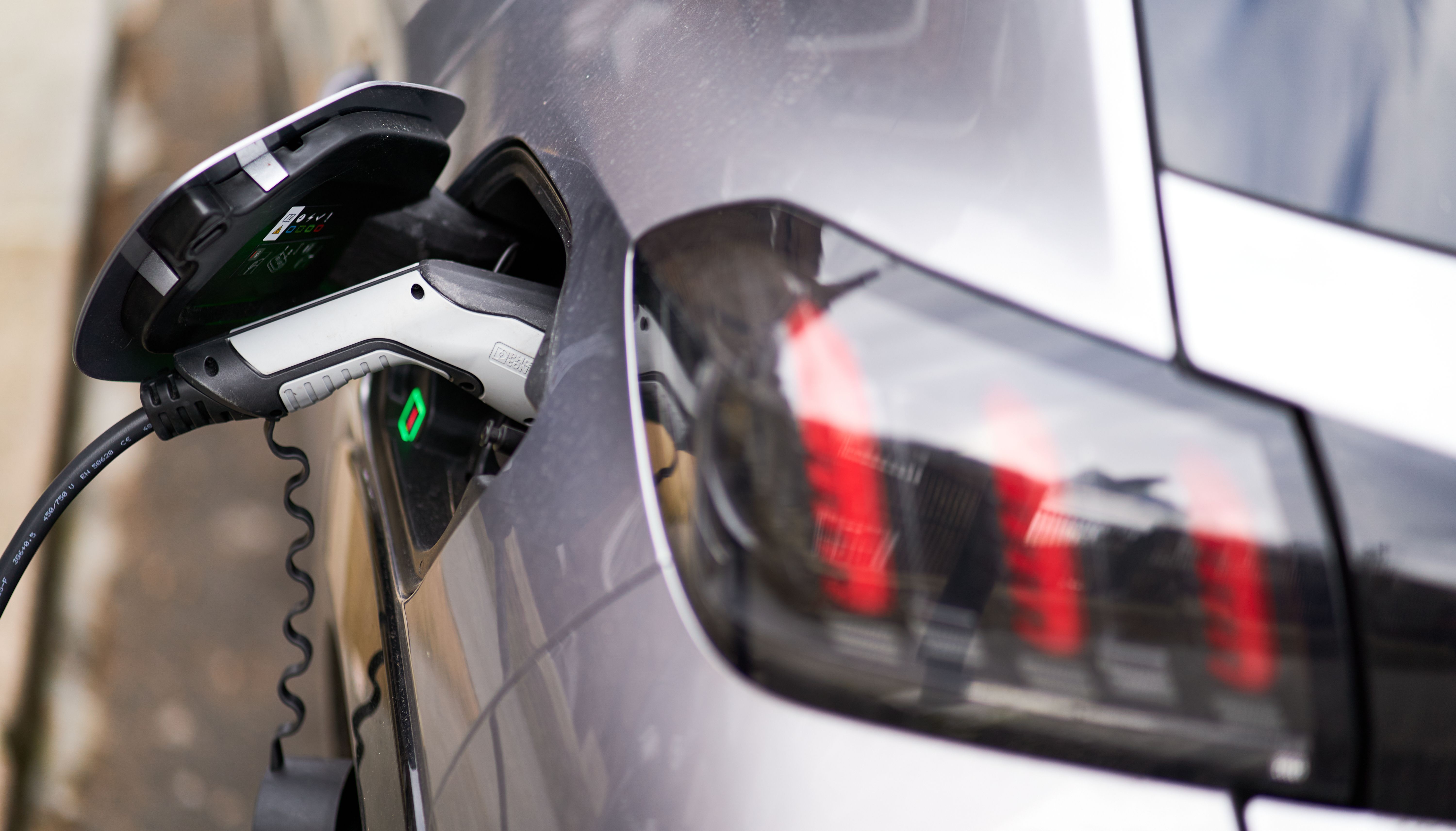 A Peugeot being charged using a Source London EV charging point.